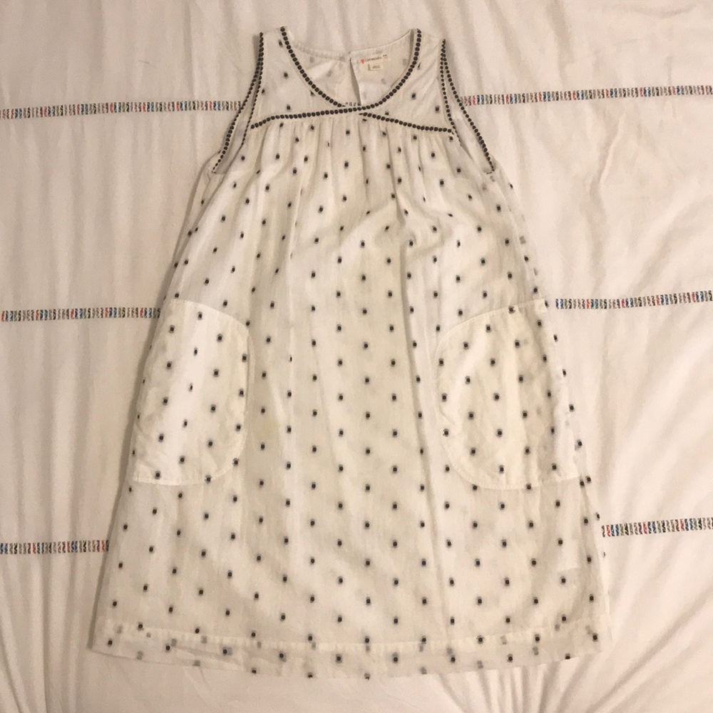 A sleeveless dress with black specks.